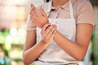 Buy stock photo Wrist pain, woman and closeup of hand, working and nursery for small business, gardening or problem. Girl, entrepreneur and arthritis in shop, store or joint injury with job at sustainable workplace