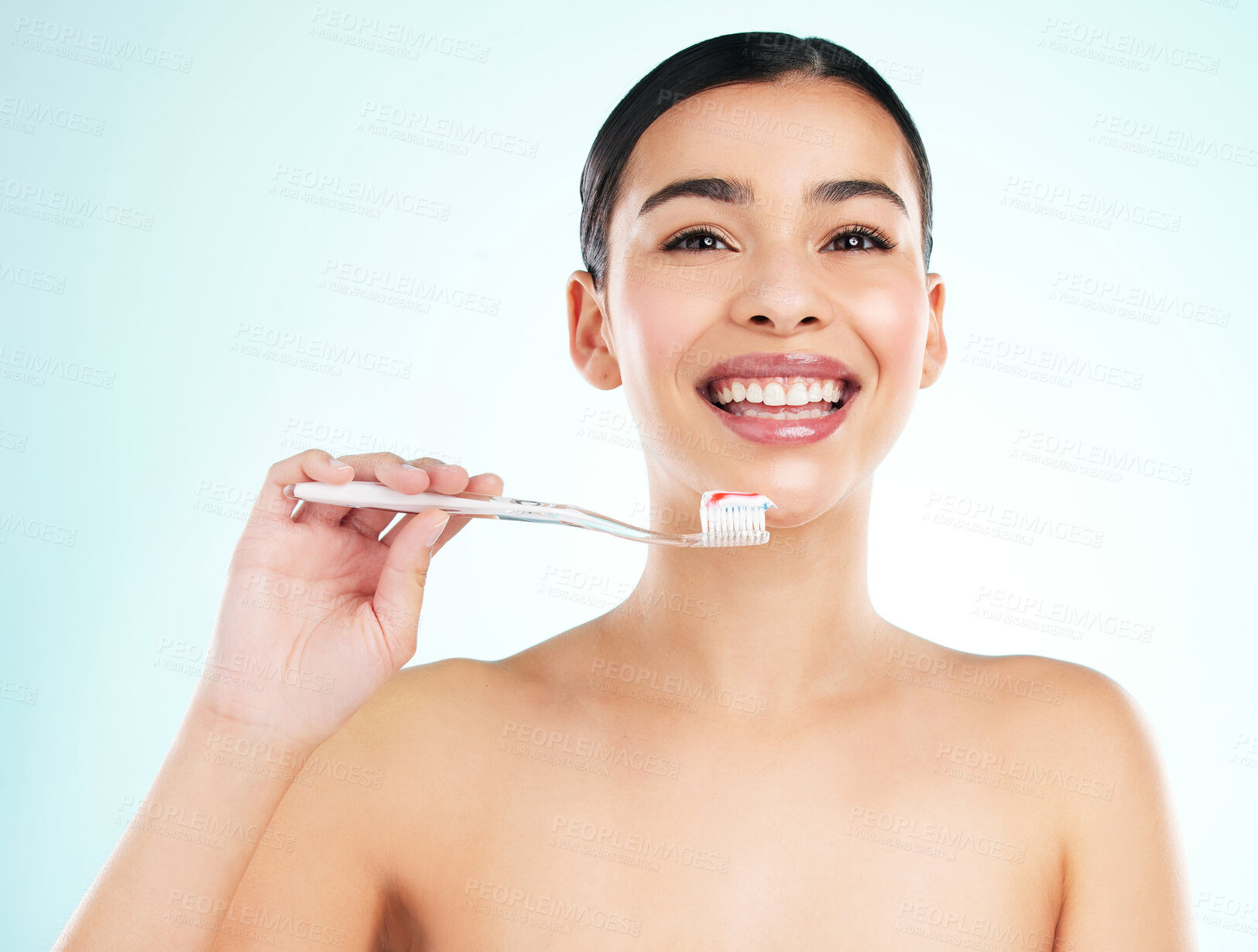 Buy stock photo Washing, teeth and smile of woman, toothbrush and routine for hygiene in morning, studio and oral health. Blue background, toothpaste and cleaning of tooth, bacteria and dental for mouth and portrait