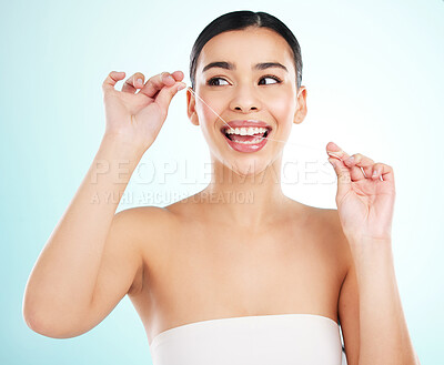 Buy stock photo Happy, floss and woman in studio, routine and cleaning of teeth for oral health, dental and smile. Blue background, hygiene and washing of tooth, maintenance and joy for gums and treatment of mouth