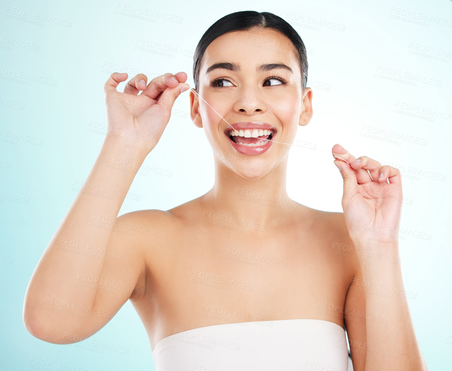 Buy stock photo Happy, floss and woman in studio, routine and cleaning of teeth for oral health, dental and smile. Blue background, hygiene and washing of tooth, maintenance and joy for gums and treatment of mouth