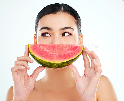 Buy stock photo Studio shot of an attractive young woman posing with a watermelon against a light background