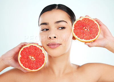 Buy stock photo Beauty, woman and grapefruit for skincare with wellness, collagen glow and tropical diet in studio. Model, citrus fruit and vitamin c for skin detox, inflammation and nutrition by white background