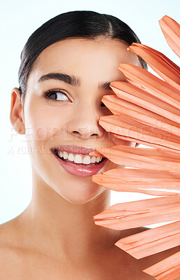 Buy stock photo Studio shot of an attractive young woman posing with an orange plant against a light background