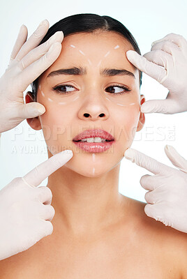 Buy stock photo Studio shot of an attractive young woman having some plastic surgery done against a light background