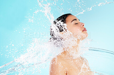 Buy stock photo Cleaning, hygiene and water splash with woman in studio on blue background for skincare. Beauty, hydration and wellness with satisfied or wet model in spa shower for calm, relaxation and washing