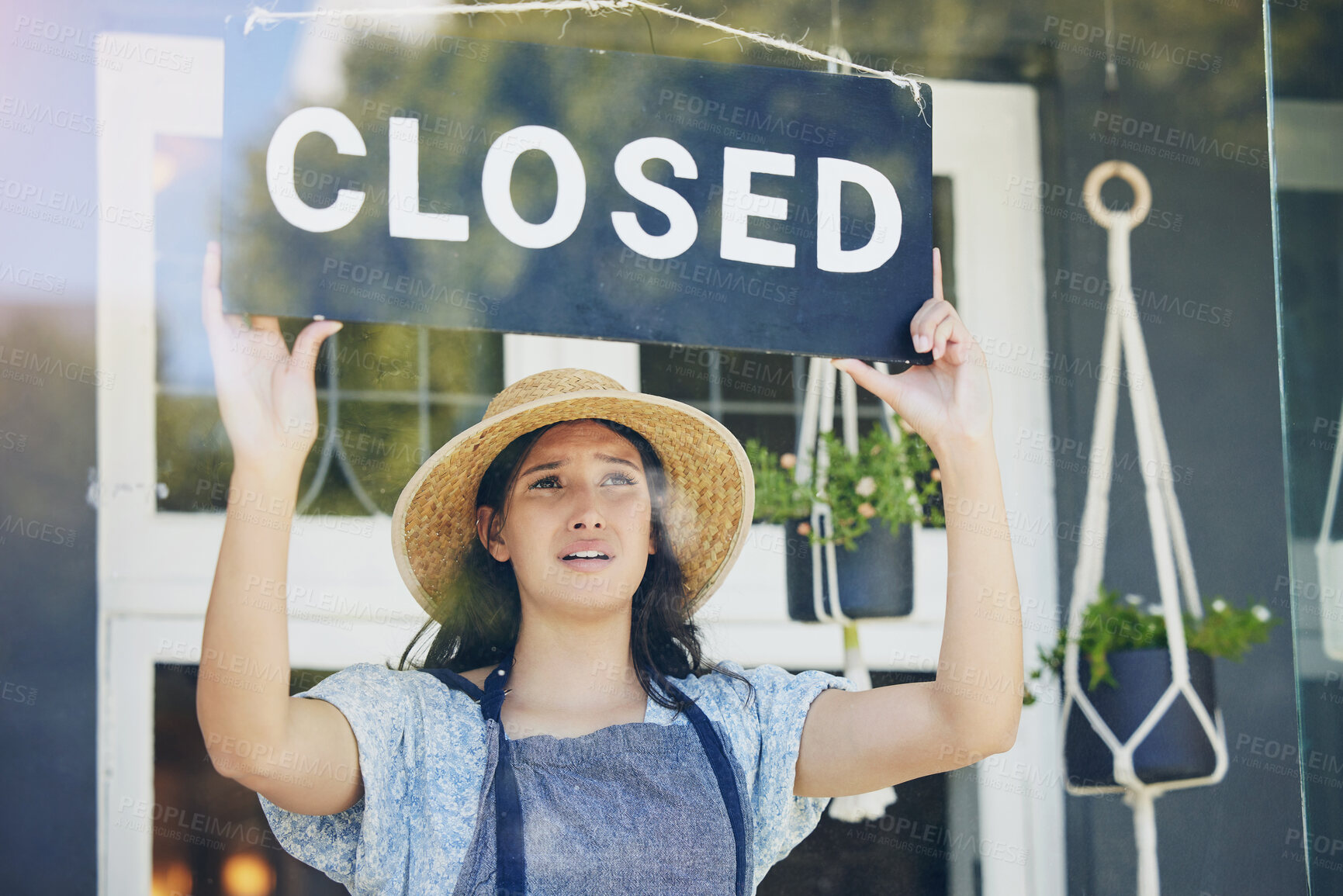 Buy stock photo Closed, woman and floral business with sign, recession and inflation with bankruptcy, emotion and failure. Person, entrepreneur or worker with unemployment, stagflation or stress with store or upset