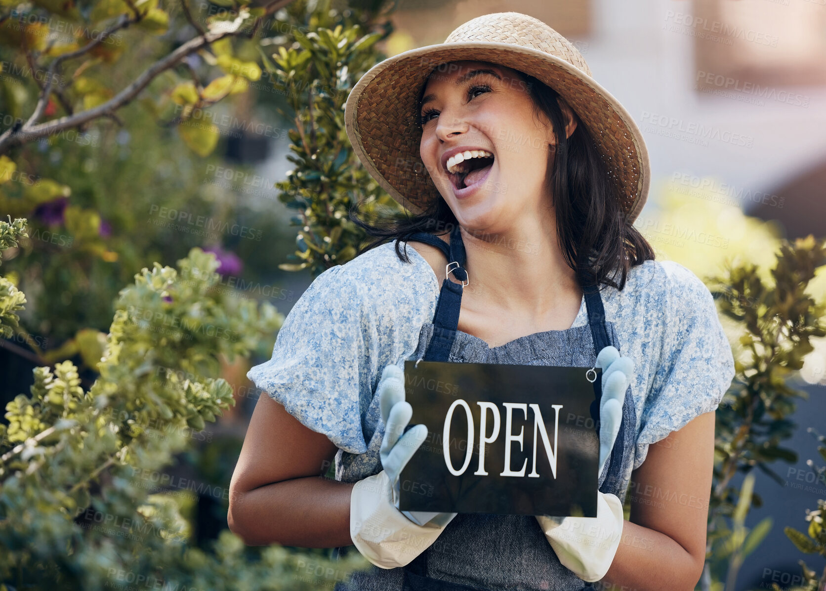 Buy stock photo Happy, nursery and open with a woman holding a sign outside of shop for gardening or landscaping. Small business, garden center and an excited young female entrepreneur opening her new floral store