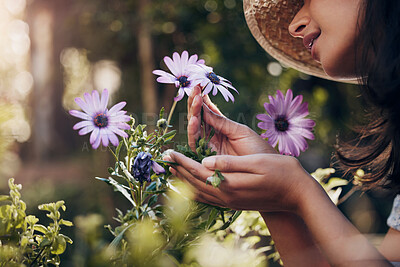 Buy stock photo Girl, hand and smell flower in garden for floral aroma, relaxation and happiness for nursery blossom or bloom. Female florist, nature and plants for sustainability or ecology, peaceful and outdoor.