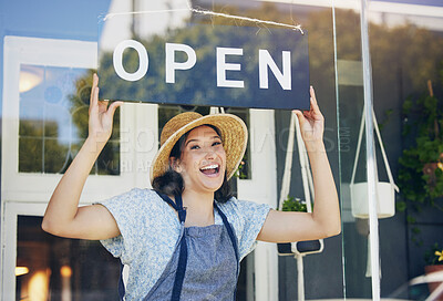 Buy stock photo Portrait, plant nursery and open with a woman hanging a sign in the window of her shop for gardening. Small business, garden center and an excited young female florist opening her new flower store