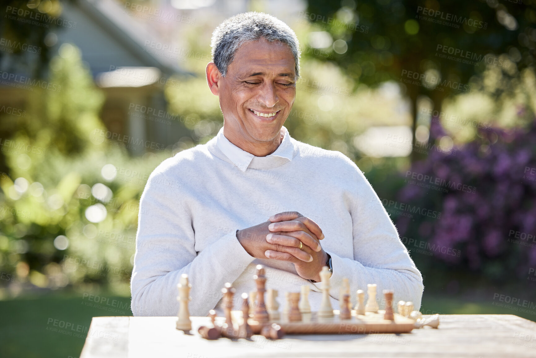 Buy stock photo Senior man, chess and play in outdoor, planning and game challenge in retirement for hobby. Male person, happy and garden for skill in backyard, tournament and nature for competition or contest