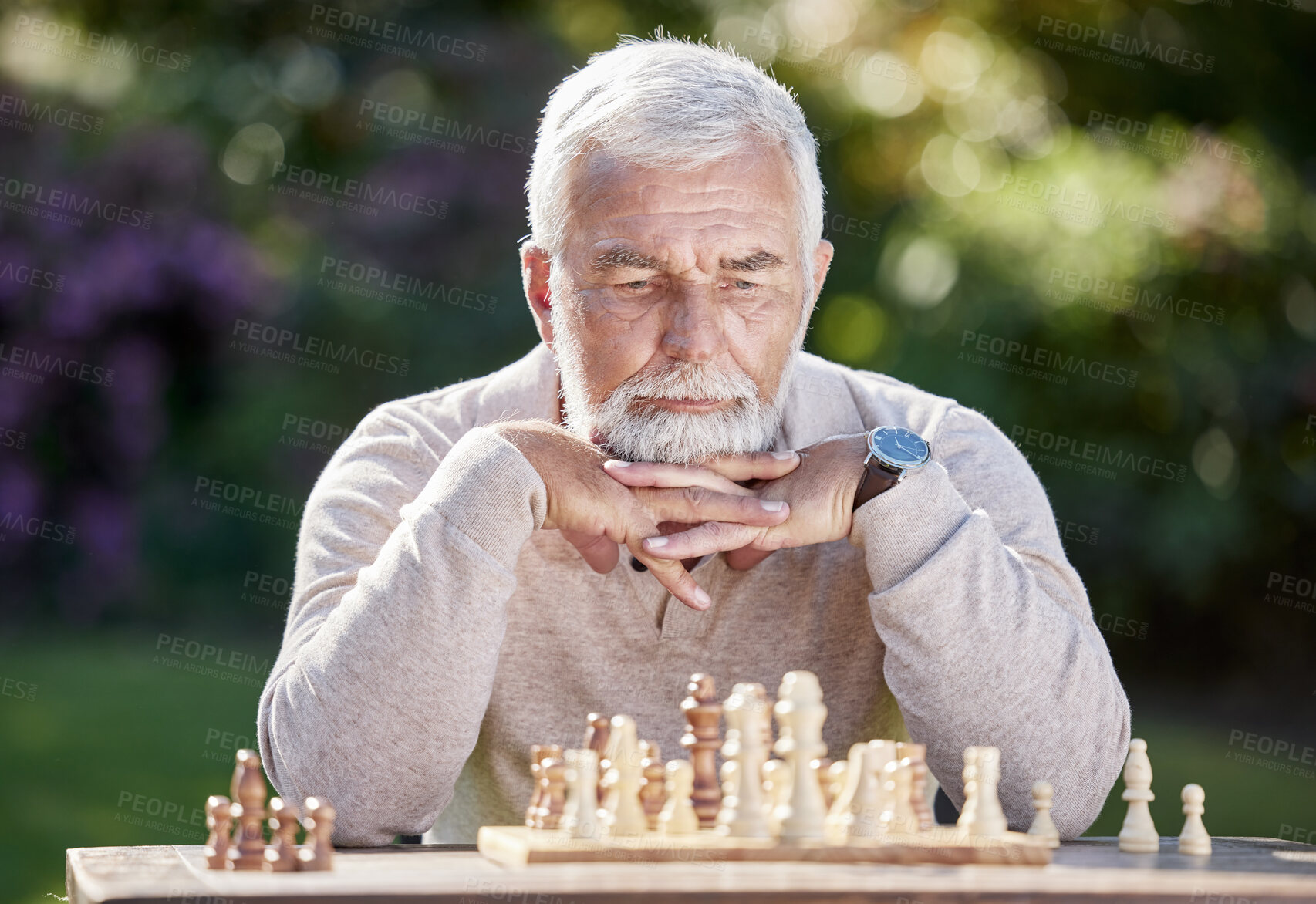 Buy stock photo Thinking, retired man and playing chess in garden for challenge and strategy in nature. Elderly male person, planning and board game in countryside with intelligence and focus at table in park