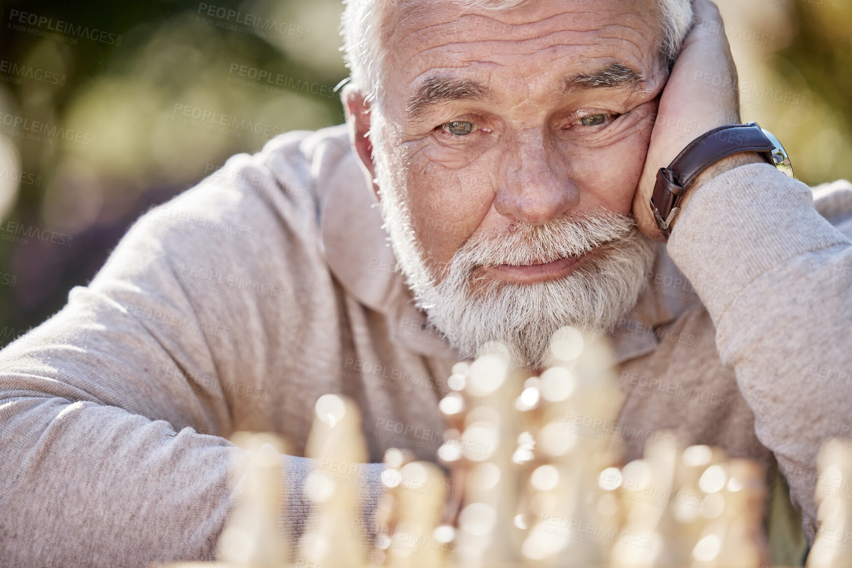 Buy stock photo Senior man, chess and thinking in outdoor, planning and game challenge in retirement for hobby. Person, strategy and garden for skill in backyard, tournament and nature for competition or contest