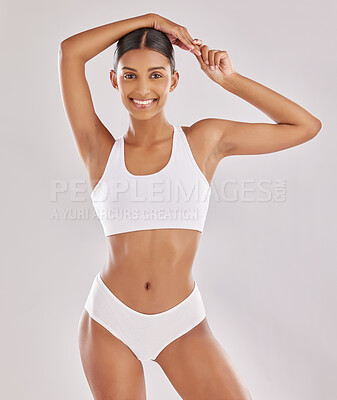 Slim body type. Young woman in underwear is in the studio with