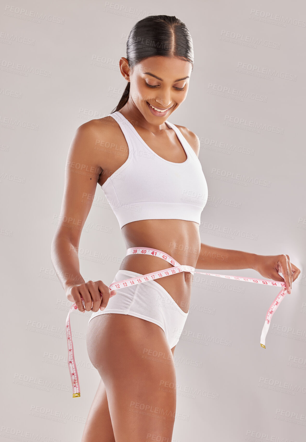 Buy stock photo Happy woman in underwear, body and measuring tape, lose weight and health with diet isolated on studio background. Healthy lifestyle, detox and liposuction, female person check progress of weightloss