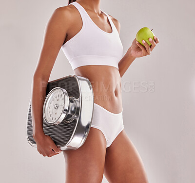 Buy stock photo Woman in underwear, body and apple with scale and lose weight, health with fitness and nutrition on studio background. Female model, healthy food and fruit with diet, detox and vegan lifestyle