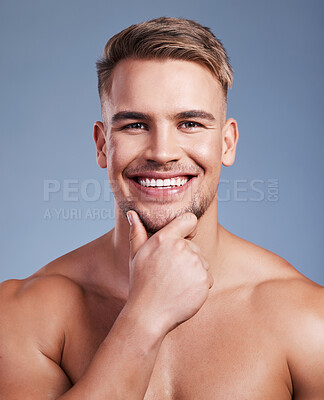 Buy stock photo Closeup shot of a handsome young man smiling while posing against a studio background