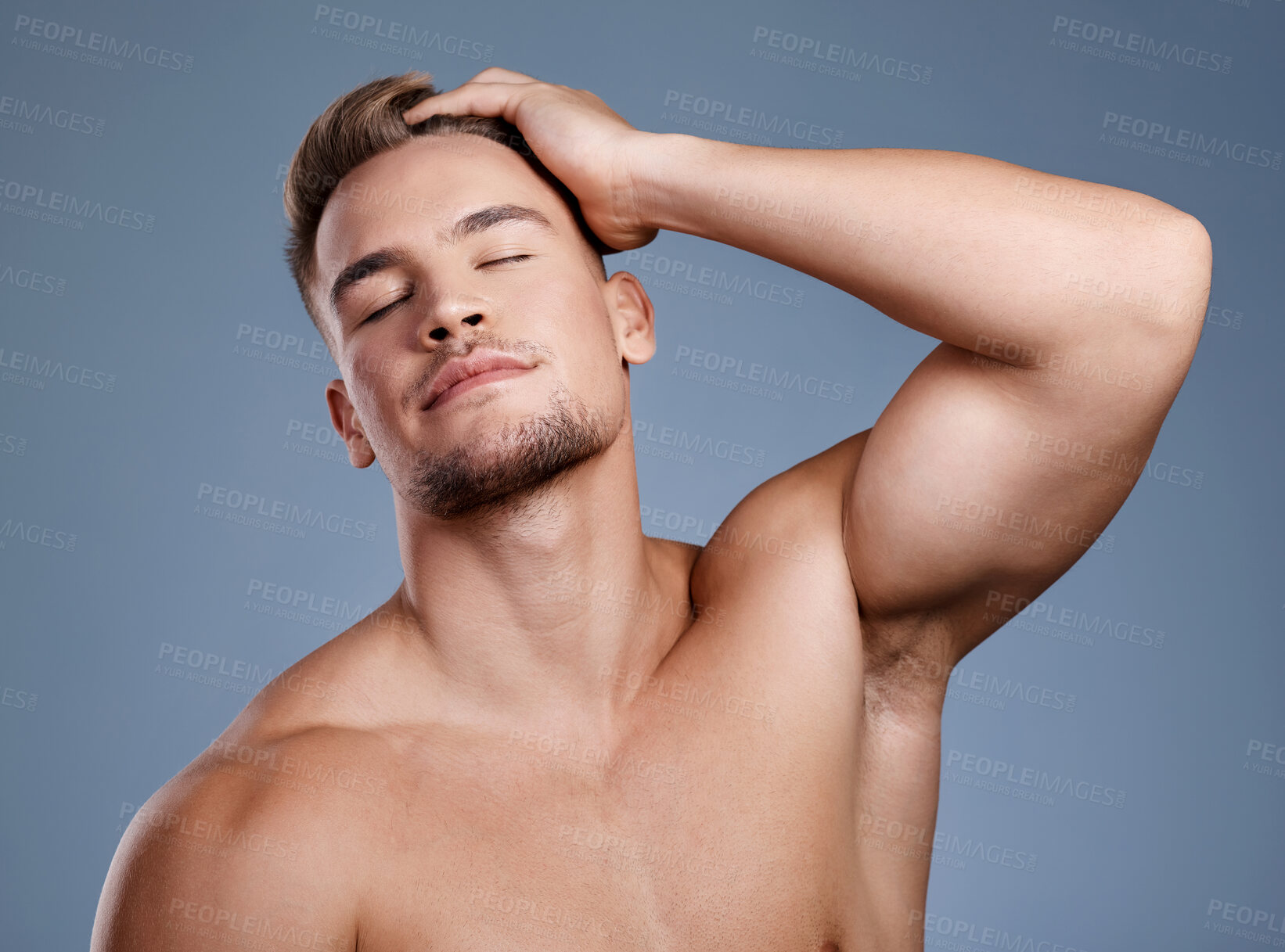 Buy stock photo Studio shot of a handsome young man posing against a grey background