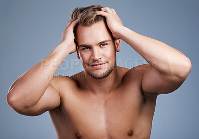 Buy stock photo Studio shot of a handsome young man posing against a grey background