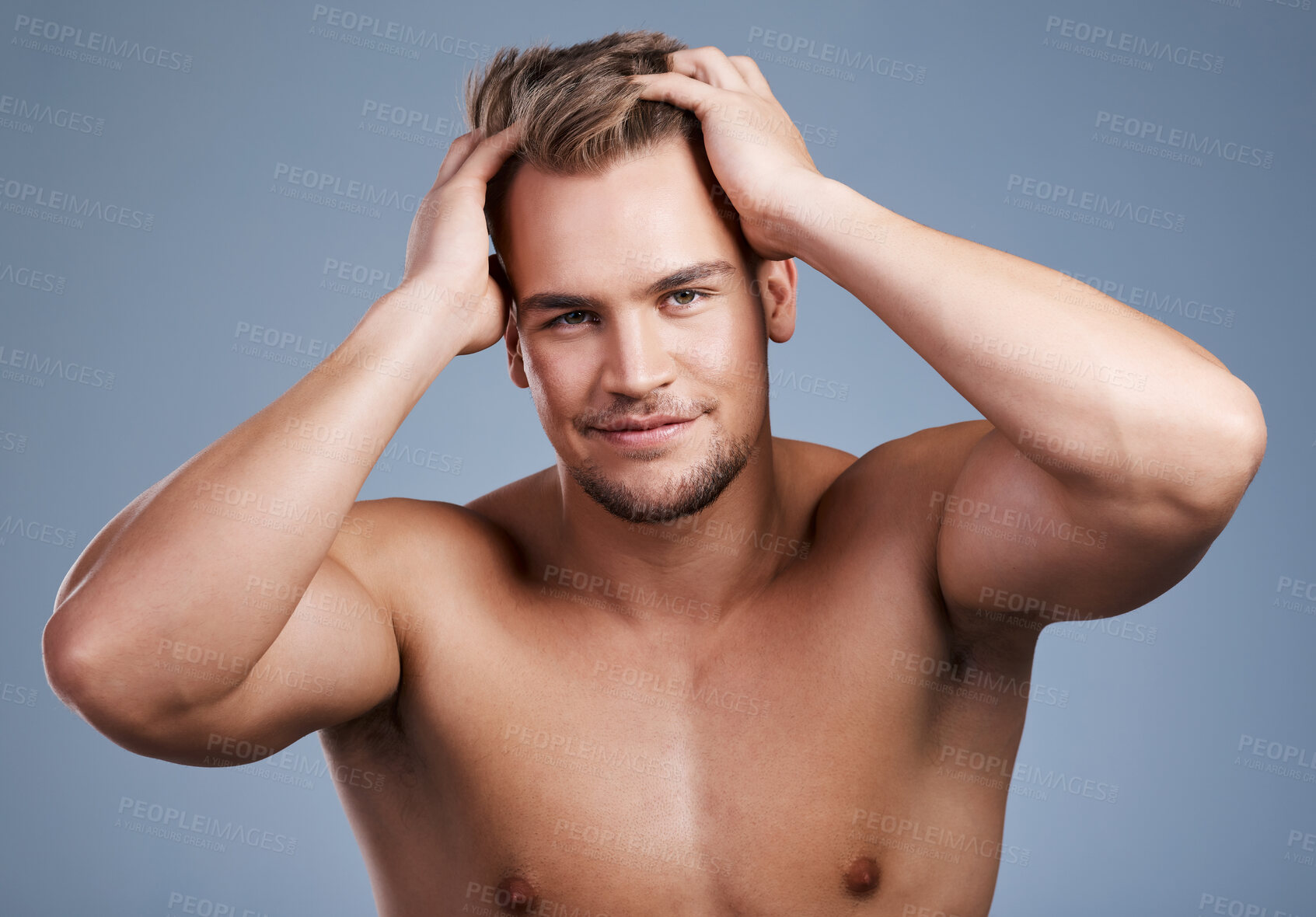 Buy stock photo Studio shot of a handsome young man posing against a grey background