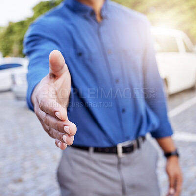 Buy stock photo Cropped shot of an unrecognizable businessman standing with his hand outstretched for a handshake outside