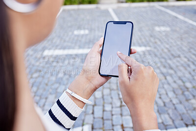 Buy stock photo Shot of an unrecognizable businesswoman using a smartphone outside