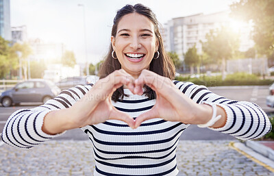 Buy stock photo Shot of an young businesswoman making a heart shaped gesture with her hands outside