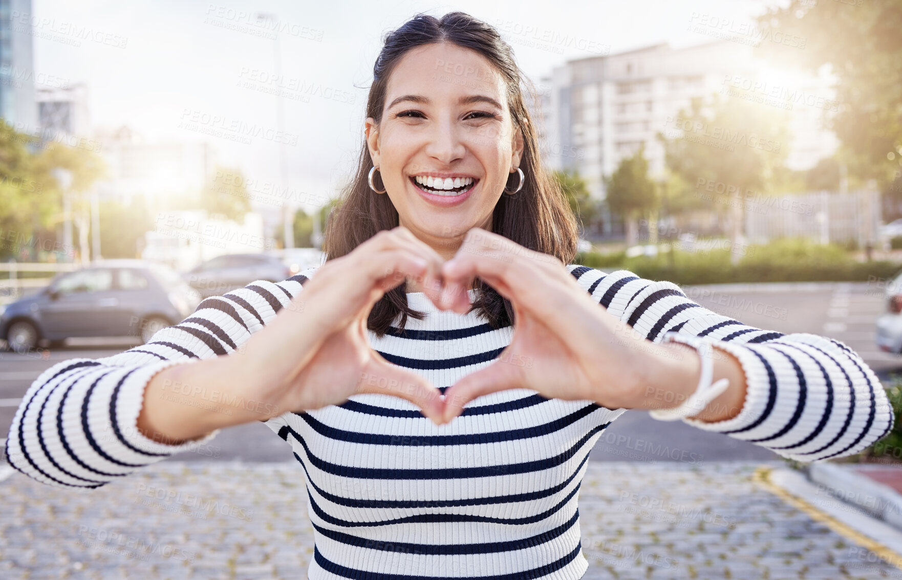 Buy stock photo Heart hands, portrait and smile with woman in city for summer excitement, love or romance. Emoji, face and flirting with happy person outdoor in sunny urban town for commute or travel to location