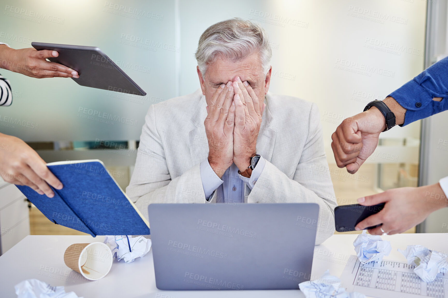 Buy stock photo Shot of a mature businessman looking overwhelmed in a demanding work environment