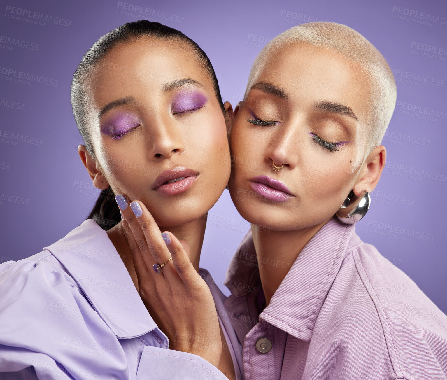 Buy stock photo Shot of two beautiful young women posing in purple