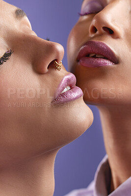 Buy stock photo Cropped shot of two young women wearing purple make-up