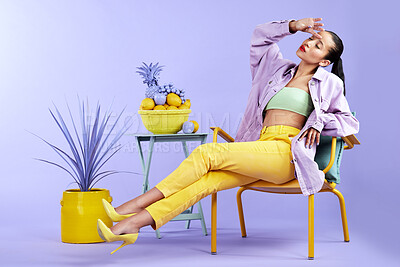 Buy stock photo Full length studio shot of an attractive young woman dressed in funky attire against a purple background