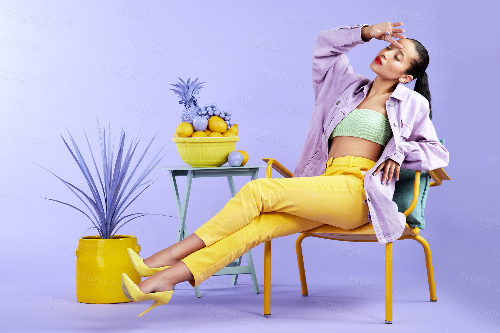 Buy stock photo Full length studio shot of an attractive young woman dressed in funky attire against a purple background