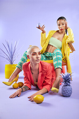 Buy stock photo Full length shot portrait of two attractive young women dressed in funky attire against a purple background