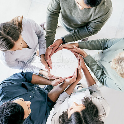 Buy stock photo High angle shot of a group of unrecognizable businesspeople forming a circle with their hands at work