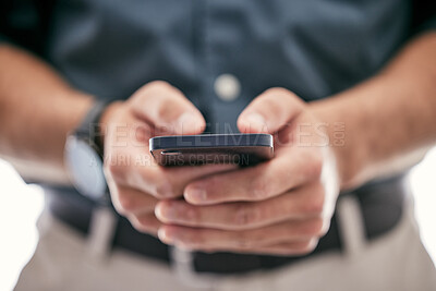 Buy stock photo Shot of an unrecognizable businessman using a smartphone in a modern office