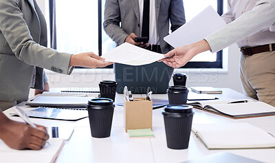 Buy stock photo Closeup shot of a group of businesspeople going through paperwork during a meeting in an office