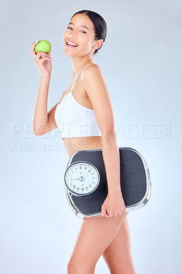 Buy stock photo Portrait, scale and happy woman with apple in studio for health, diet and weight loss detox on grey background. Nutrition, wellness and face of girl model with fruit or organic, vegan or gut health