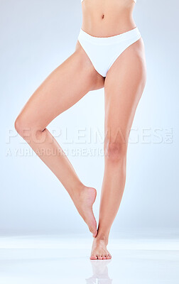 Buy stock photo Cropped shot of an unrecognisable woman showing her legs while posing in the studio