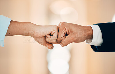Buy stock photo Shot of two unrecognizable business people fist bumping in a office
