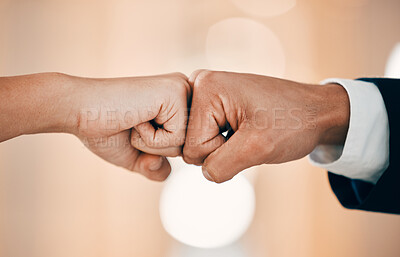 Buy stock photo Shot of two unrecognizable business people fist bumping in a office