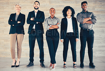 Buy stock photo Shot of a group of businesspeople standing with their arms crossed in an office at work