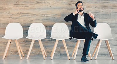 Buy stock photo Shot of a mature businessman using a phone while waiting in line at an office