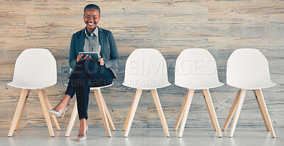Buy stock photo Shot of a young businesswoman sitting  and using a tablet in an office