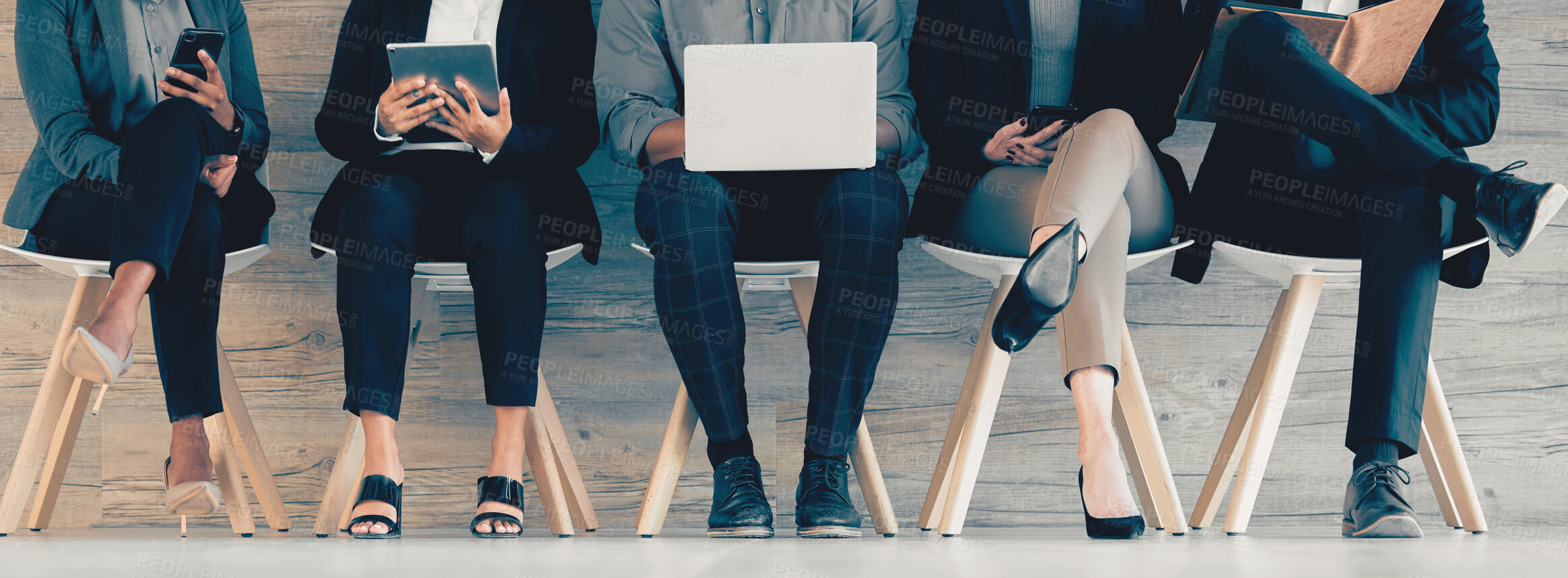 Buy stock photo Shot of a group of unrecognizable businesspeople using different forms of technology while waiting in line at an office
