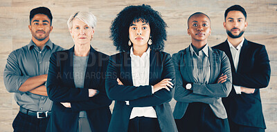 Buy stock photo Shot of a group of businesspeople standing with their arms crossed in an office at work