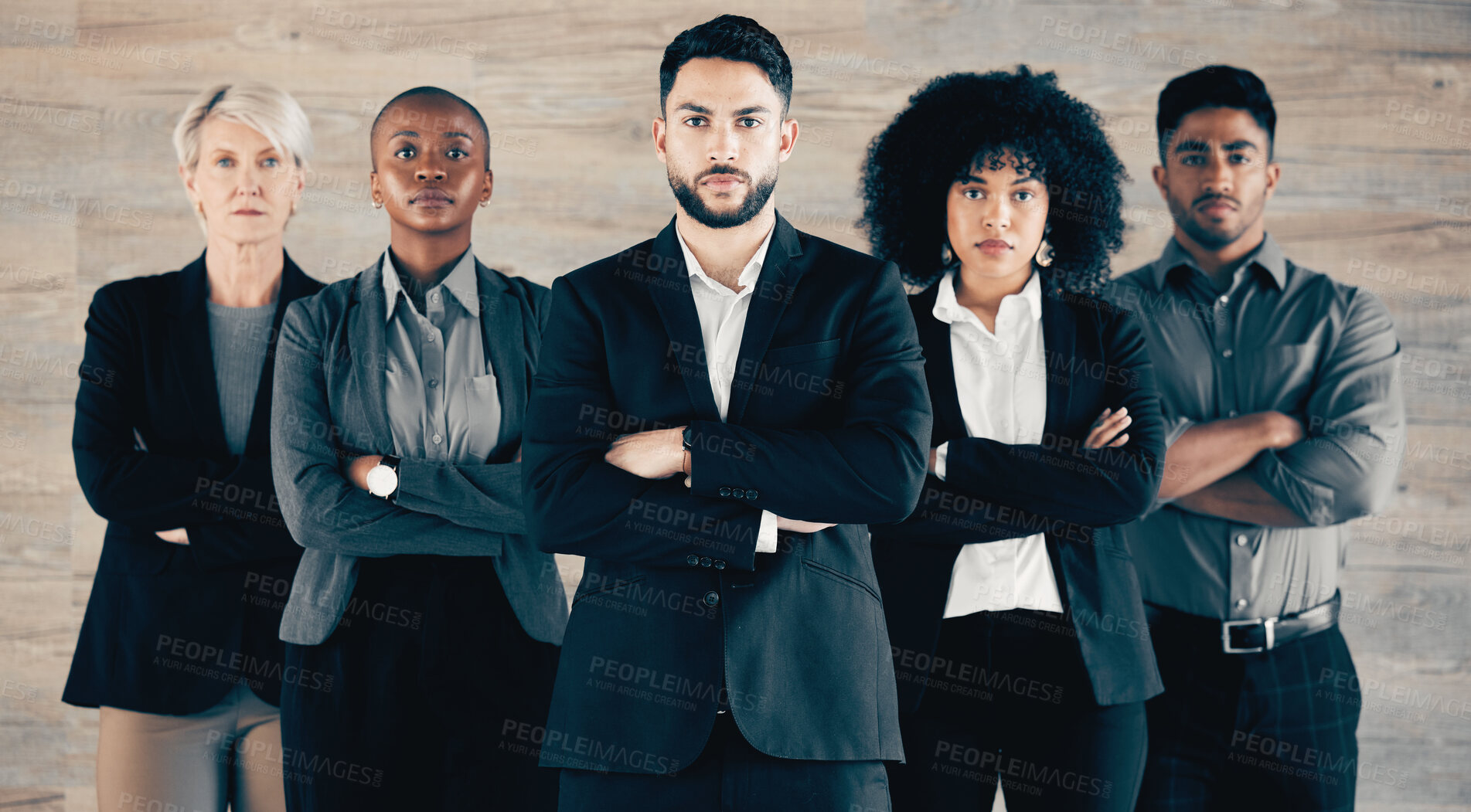 Buy stock photo Shot of a group of businesspeople standing with their arms crossed in an office at work