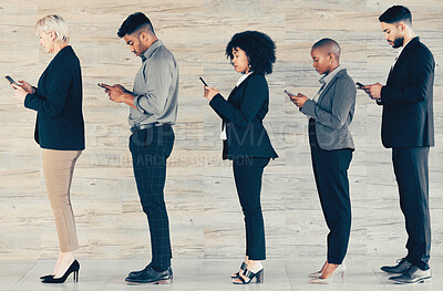Buy stock photo Shot of a group of businesspeople waiting in line and using a phone at an office