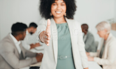 Buy stock photo Shot of a young businesswoman extending her hand out for a handshake at work