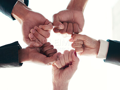 Buy stock photo Low angle shot of a group of unrecognizable businesspeople joining their hands together in a unity