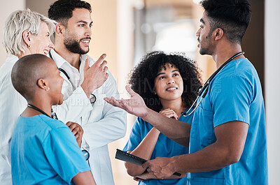 Buy stock photo Shot of a group of young doctors having a discussion in a modern office